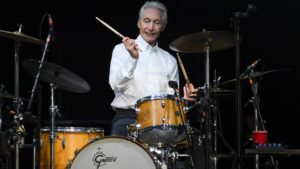 Charlie Watts playing drums on stage